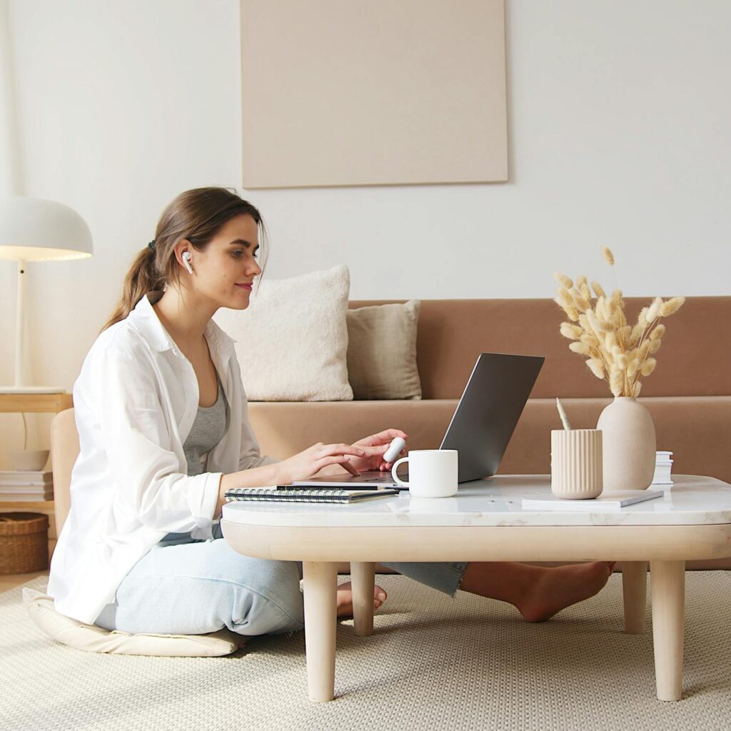 Content woman using laptop on floor